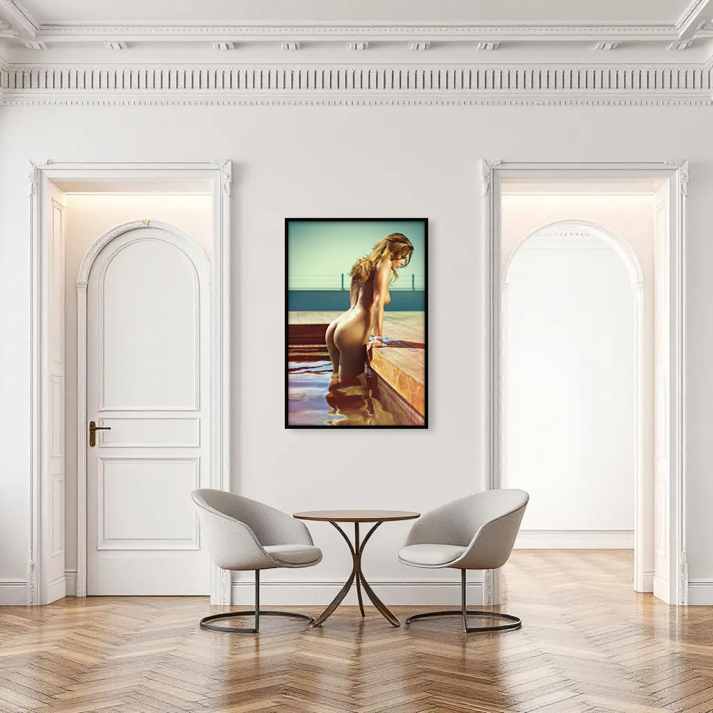 Design interior with framed photo artwork of wet nude young woman pushing herself up from pool in wooden terrace with sky in the back.