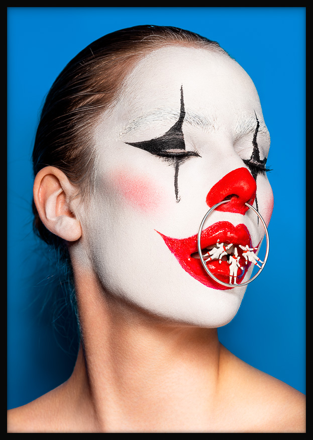 Surreal clown portrait of a female clown, eyes closed, with Pierrots balancing on a silver nose ring—mysterious, dreamlike, theatrical.