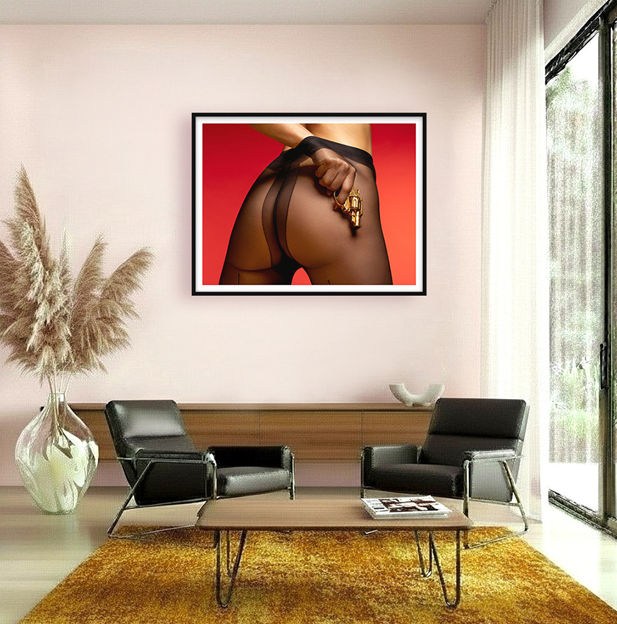 Art in interior of woman with a golden revolver beneath sheer tights—where femininity reveals its edge, and desire flirts with danger.