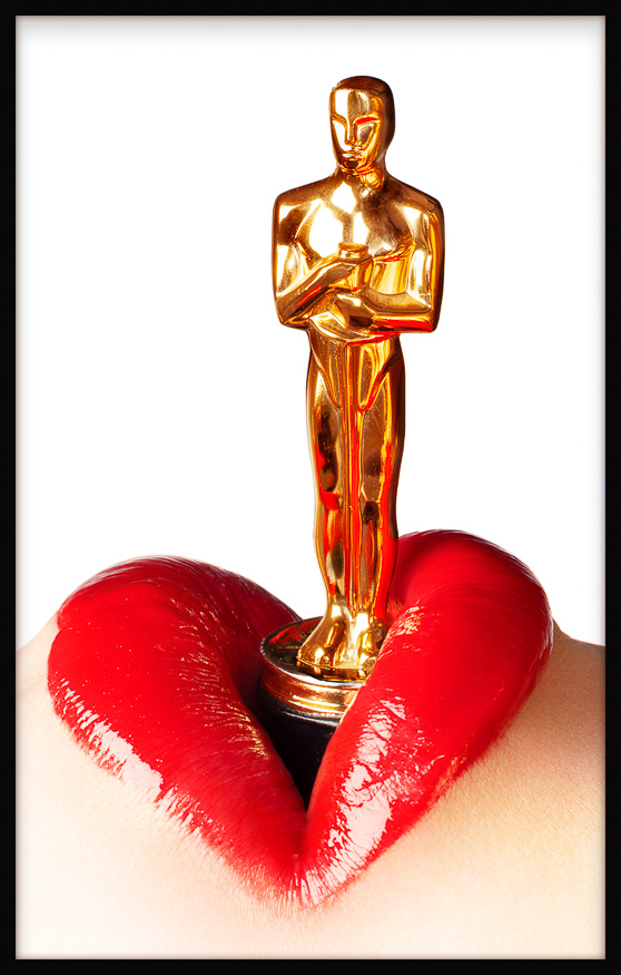 Erotic heart-shaped lips with Oscar statuette in gold nestled between, blending erotica and desire in a twist on Hollywood stardom.