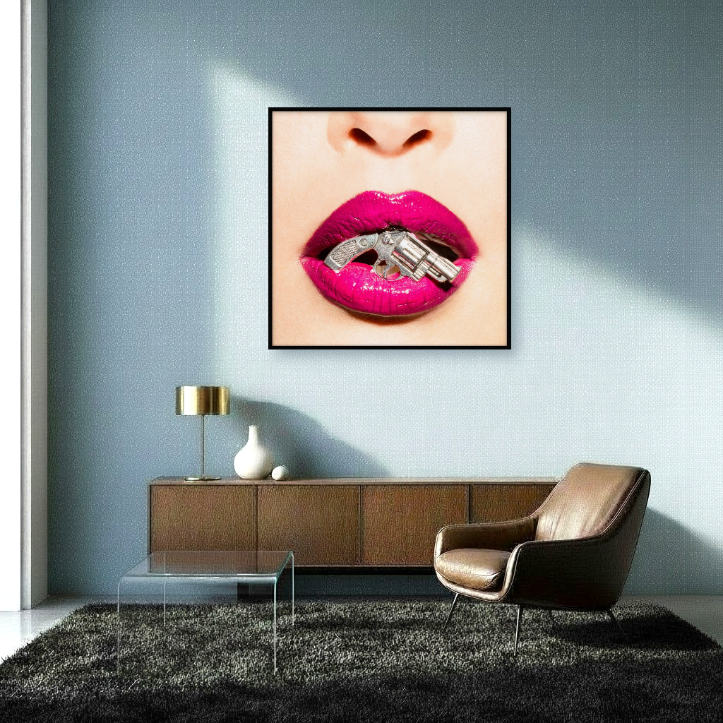 Tiny silver gun caught between pink lips, merging vulnerability and playful danger in a striking pop-art sensuality piece in interior.