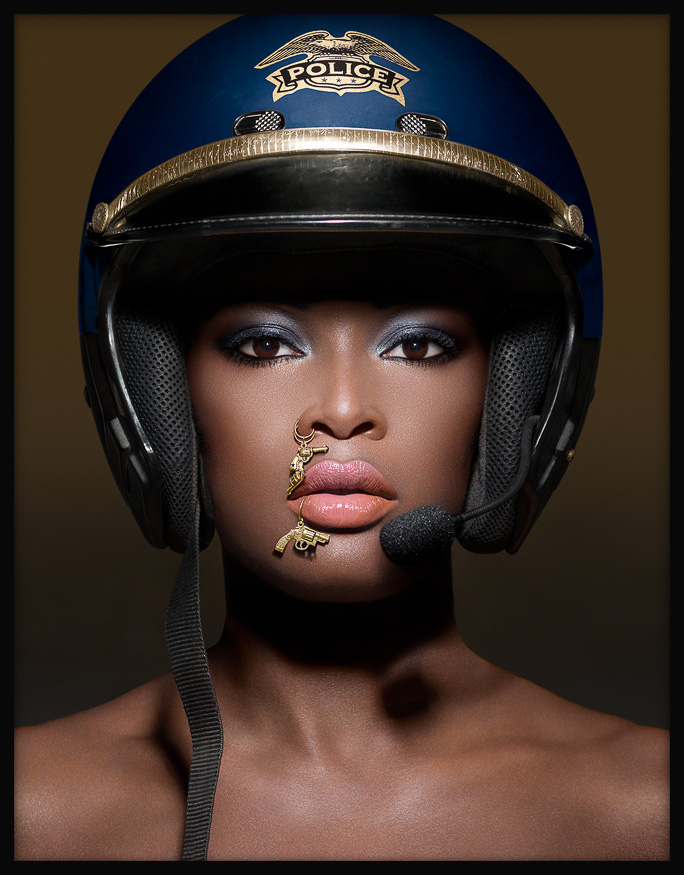 Black officer with gun piercings art: a bold portrayal of authority, race and playful power with toy gun jewelry as a statement.