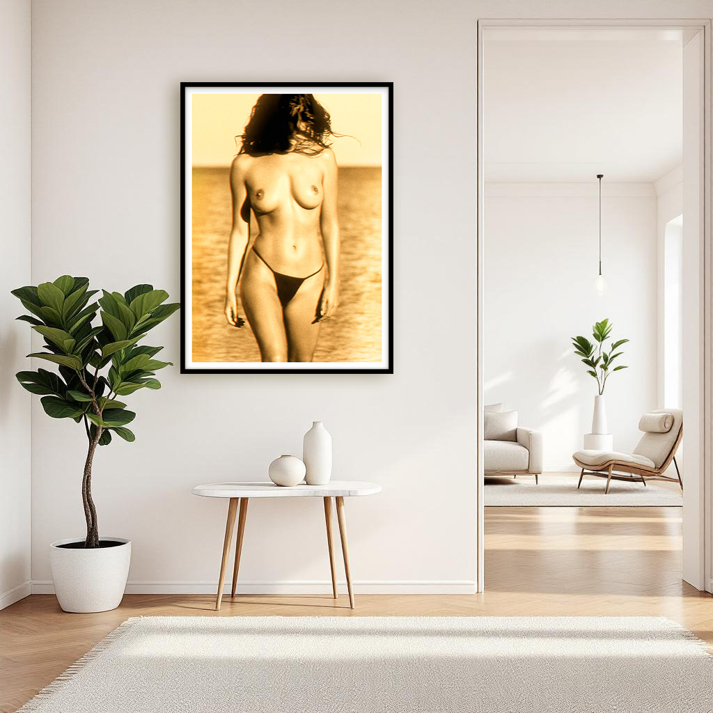 Black-and-white artwork of a young woman emerging from the sea in warm golden light, displayed on a wall in a stylish interior setting.