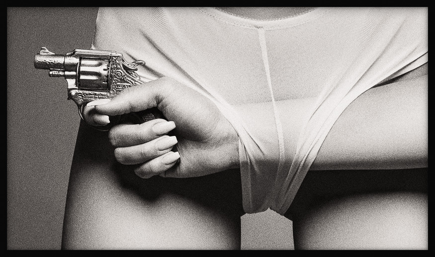 Hotshot BW Art — a woman’s hip, and a woman’s hand with a toy gun passing through panties, exploring power, desire and tension.