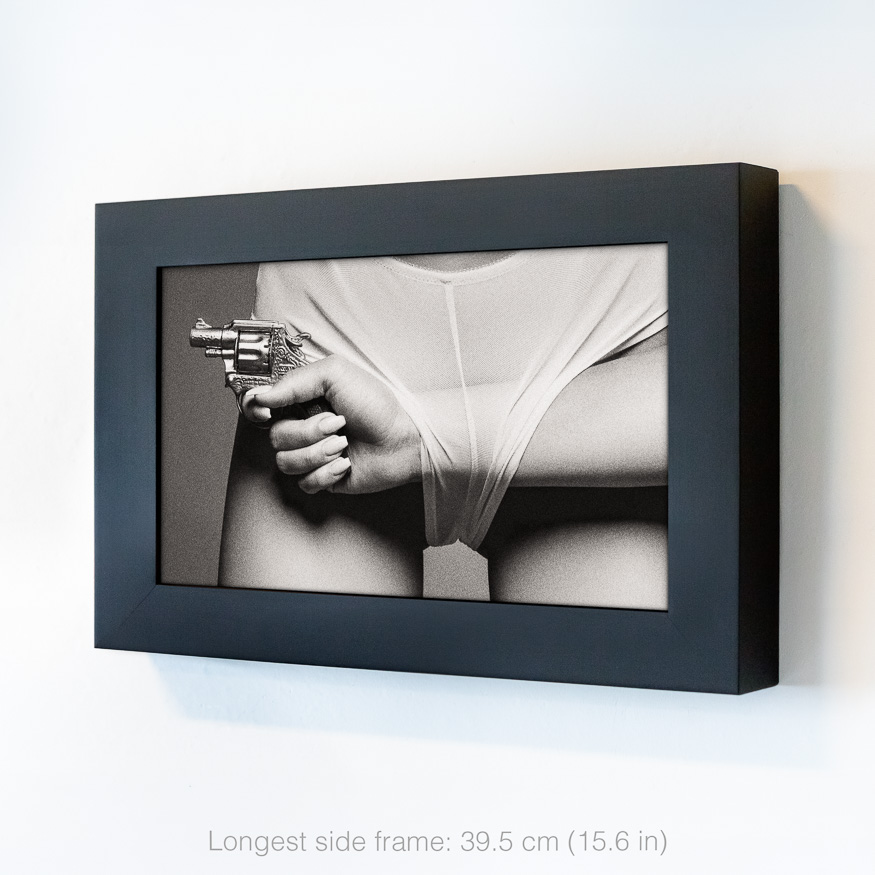 Friendly Fire BW Art — a woman’s hip, and a woman’s hand with a toy gun passing through panties, exploring power, desire and tension.