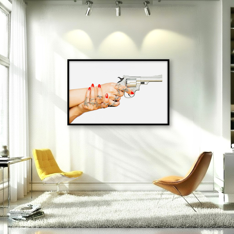 Artwork in interior of silver toy revolver and rings, showcasing bold femininity and power in a playful reinterpretation of authority.