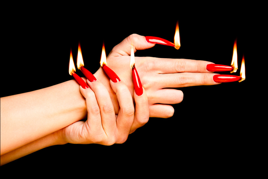 Fiery Red Nails in Gun Gesture art with long, glowing nails, creating a bold and surreal impression against a dark background.