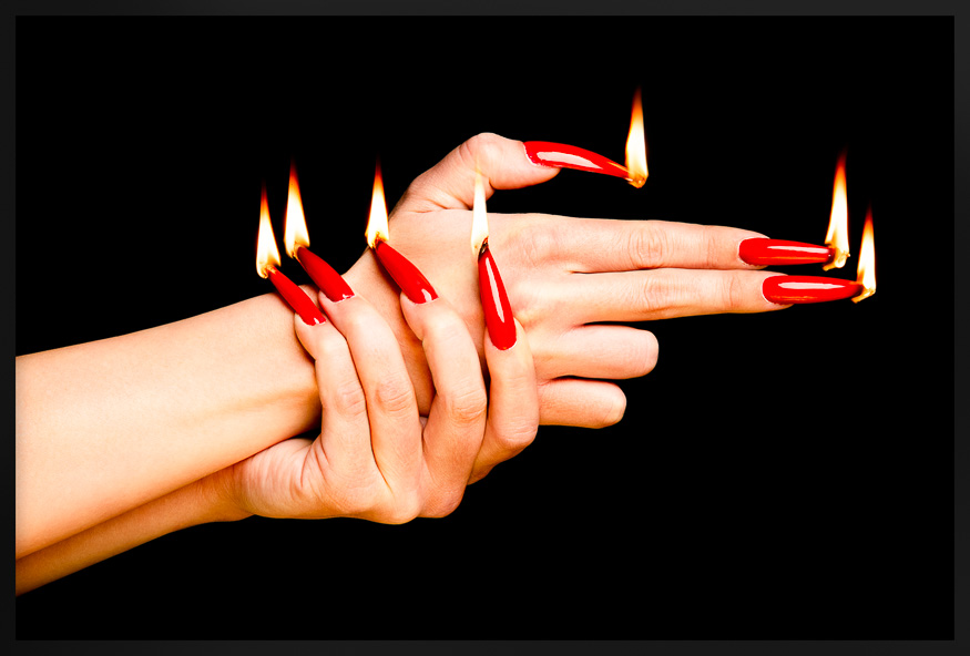 Fiery Red Nails in Gun Gesture art with long, glowing nails, creating a bold and surreal impression against a dark background.